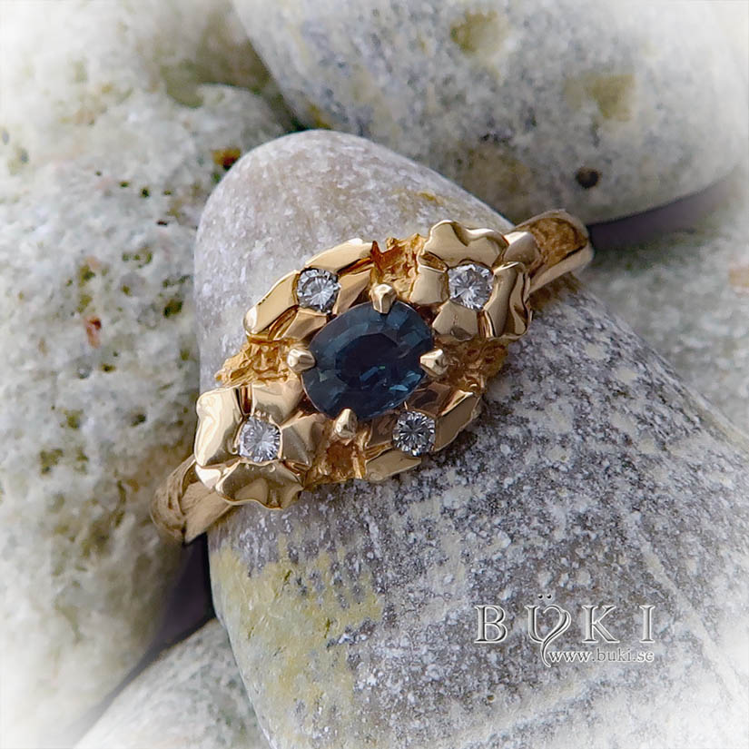 blom-ring halo-ring i 18k guld med petrol safir och diamanter